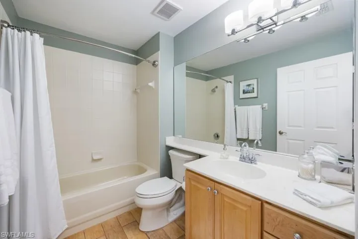Full bathroom featuring shower / bathtub combination with curtain and vanity