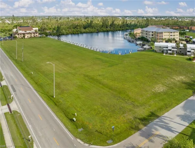 Aerial view featuring level lot with water view and access