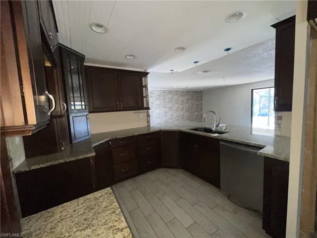 Kitchen with dark wood finish cabinetry