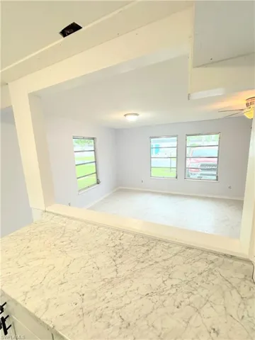 Unfurnished room featuring ceiling fan and light tile patterned floors