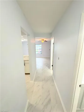 Corridor with light tile patterned floors