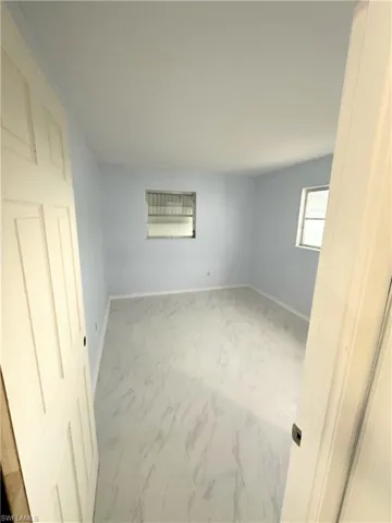 Unfurnished bedroom featuring light carpet