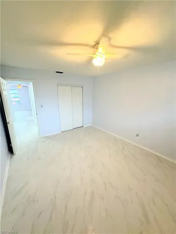 Unfurnished bedroom with a closet and ceiling fan