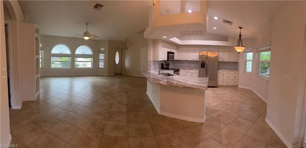 Kitchen featuring stainless steel appliances, a peninsula, visible vents, and a sink
