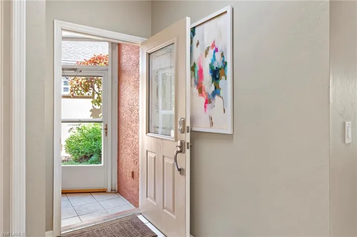 Doorway featuring plenty of natural light and light tile patterned flooring