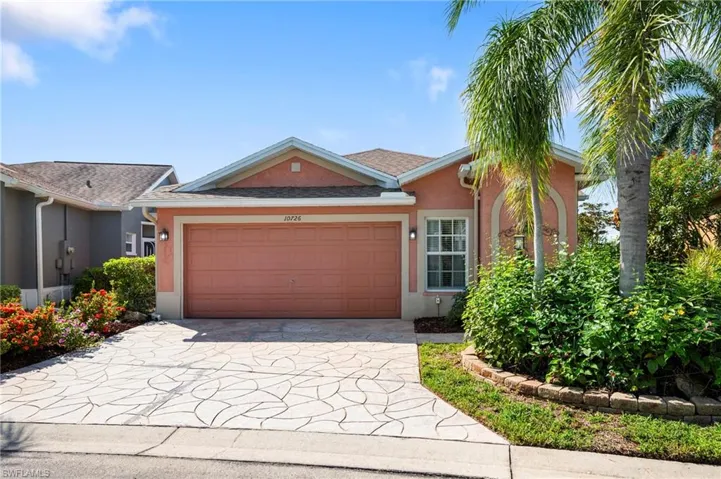 Ranch-style home with an attached garage, driveway, and stucco siding