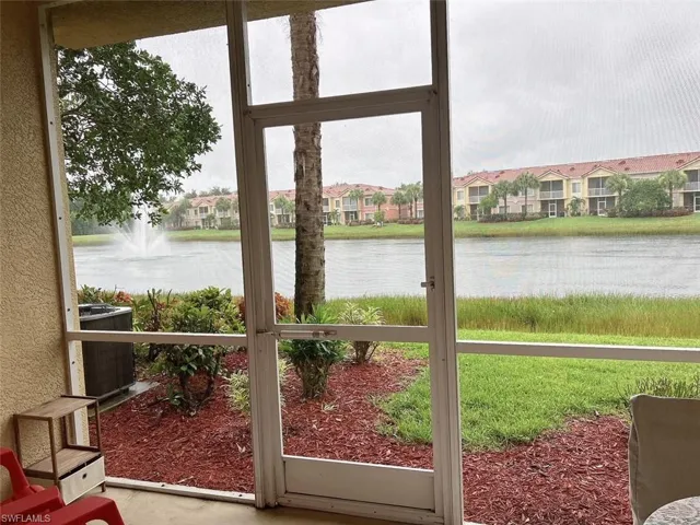 Sunroom / solarium featuring a water view