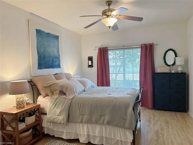 Bedroom with hardwood / wood-style flooring and ceiling fan