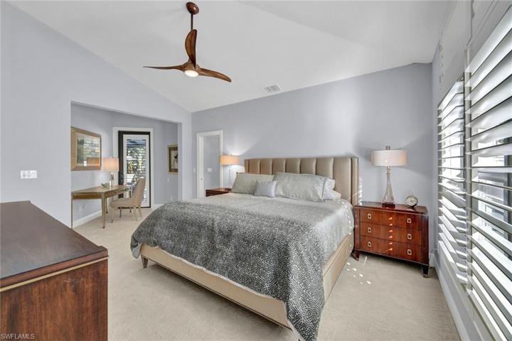 Spacious primary suite offers access to the lanai/pool.