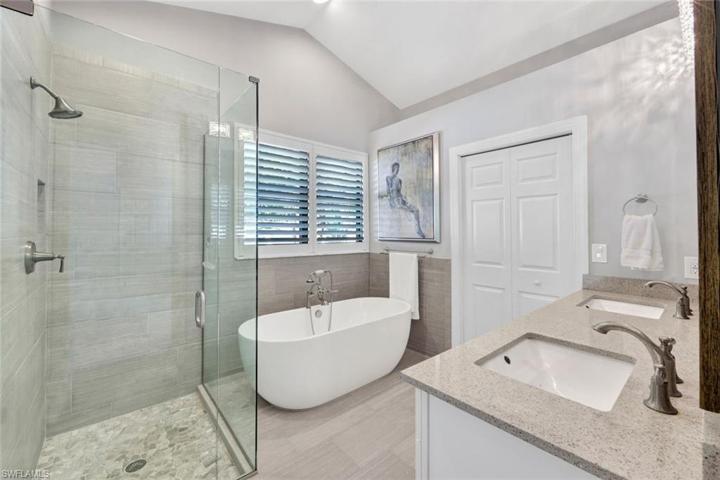 En suite expansive primary bathroom with soaking tub and dual sinks.