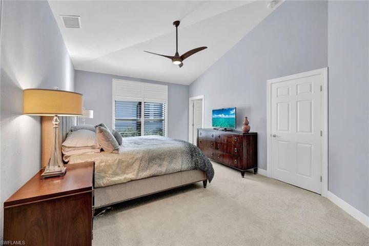 Primary bedroom features vaulted ceilings.