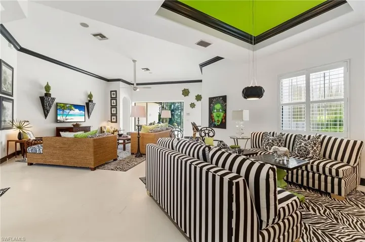 Living area featuring ornamental molding and a tray ceiling