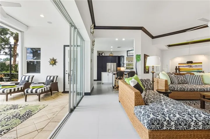 Living room with light tile patterned floors and recessed lighting