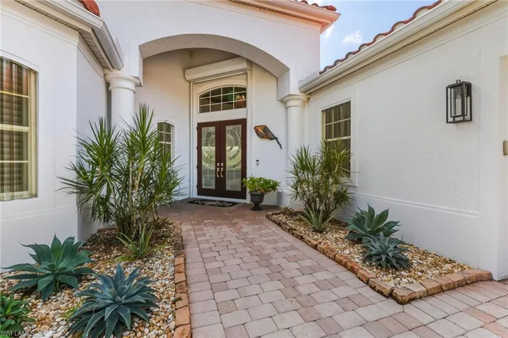 Entrance to property featuring stucco siding, french doors, and a tile roof