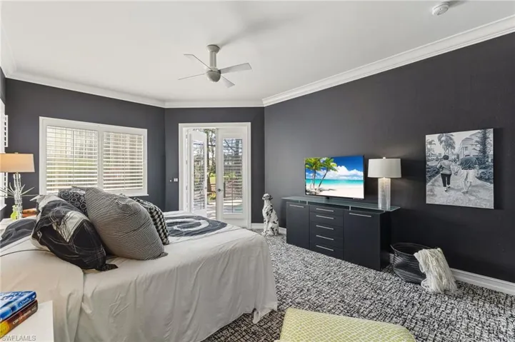 Bedroom with access to exterior, ornamental molding, carpet flooring, and a ceiling fan