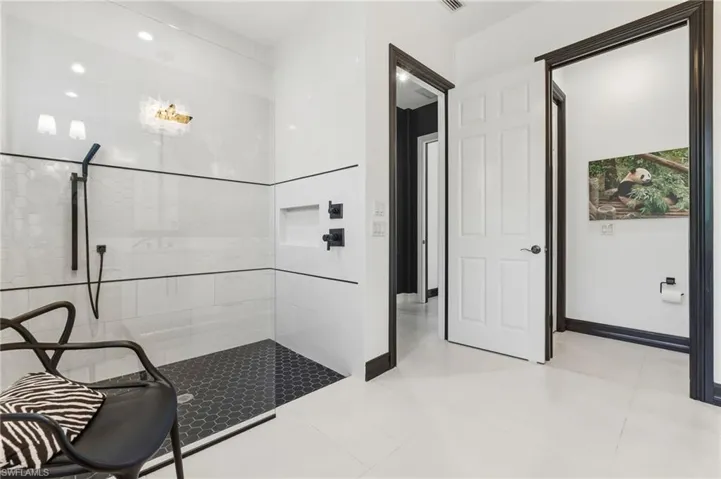 Bathroom featuring walk in shower and light tile patterned floors