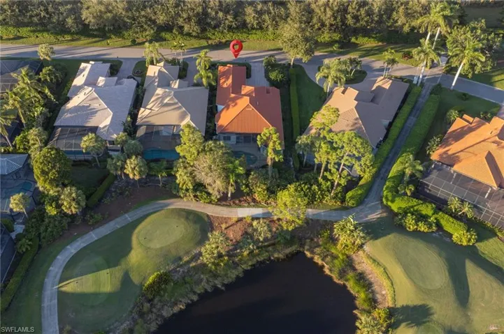Aerial overview of property's location featuring a local golf course and nearby suburban area