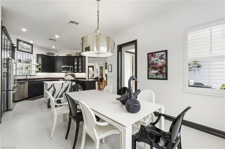 Dining room with light tile patterned flooring and recessed lighting