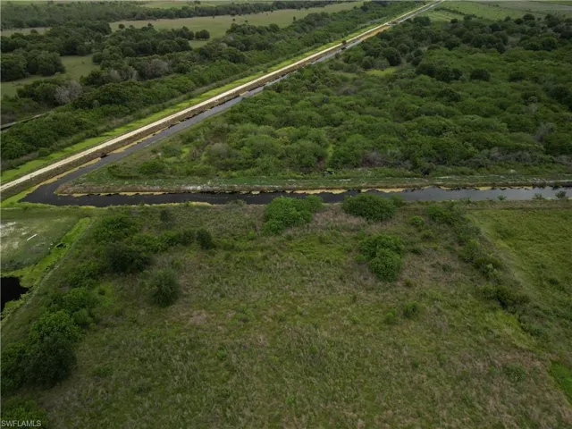 Expansive land parcel featuring natural waterways and dense green foliage
