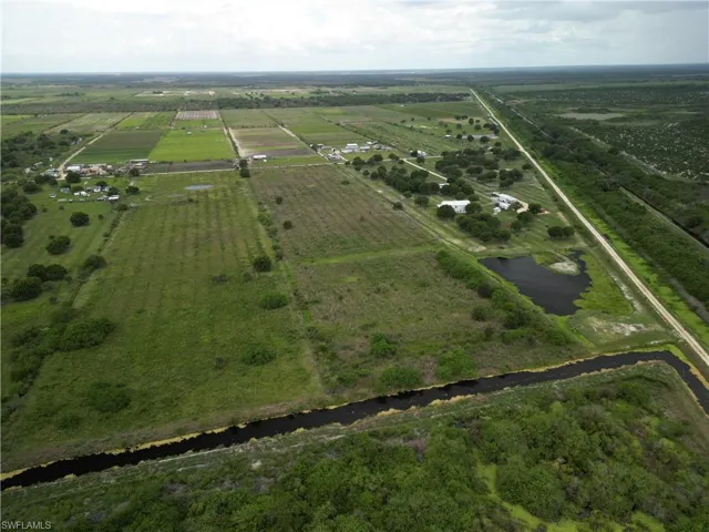 Expansive agricultural property featuring cultivated fields and a direct canal system