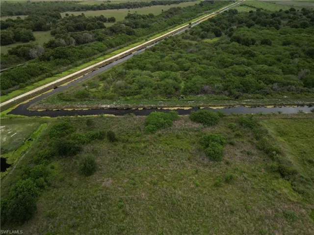 Expansive undeveloped land featuring natural vegetation and agricultural fields