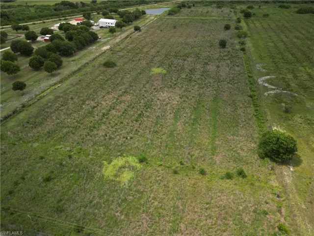 Expansive land parcel featuring open fields and scattered trees