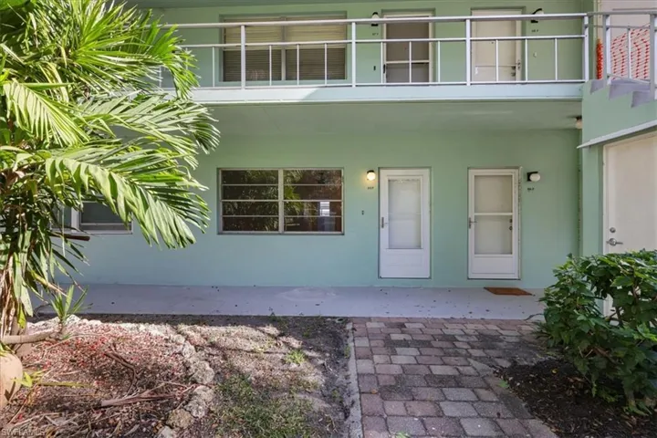 Doorway to property featuring stucco siding and a patio