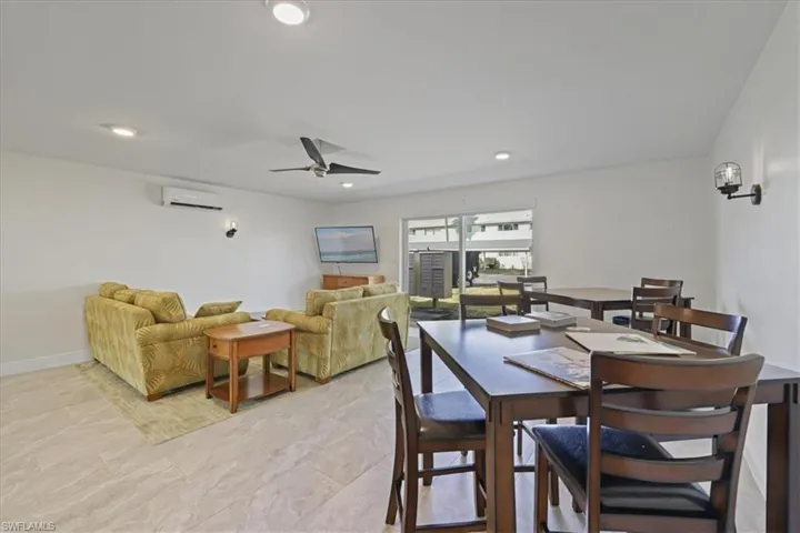 Clubhouse featuring a ceiling fan, a wall unit AC, and recessed lighting