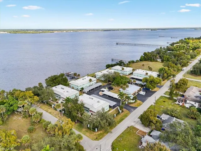 Aerial overview of property's location with a nearby body of water, a notable bridge, and nearby suburban area