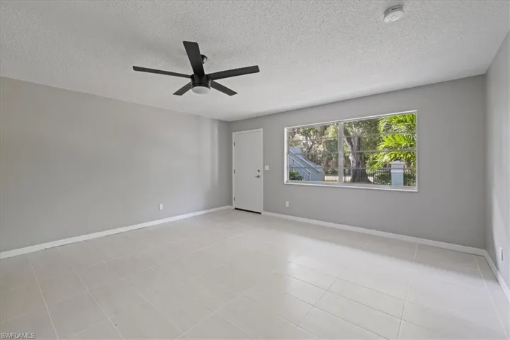 Unfurnished room featuring a textured ceiling and ceiling fan