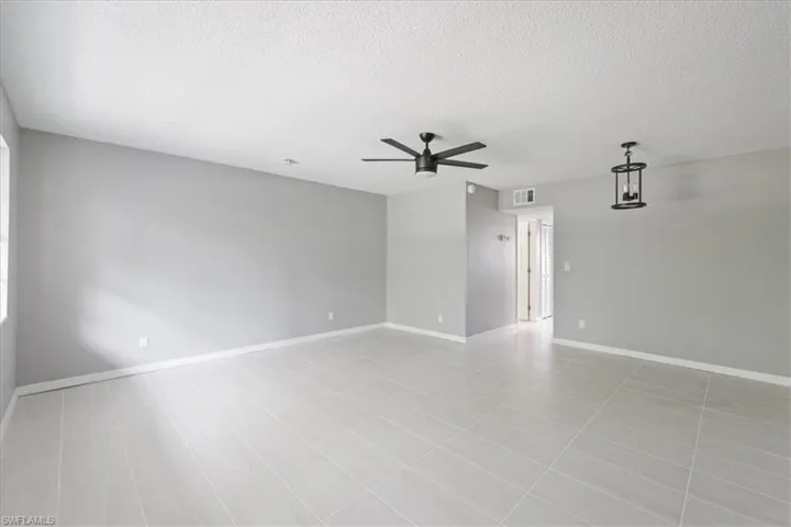 Unfurnished room with a textured ceiling and a ceiling fan