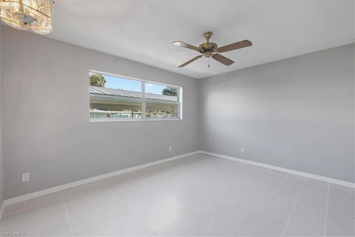 Unfurnished room featuring baseboards and a ceiling fan