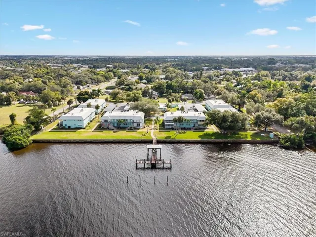 Aerial view of residential area featuring a nearby body of water