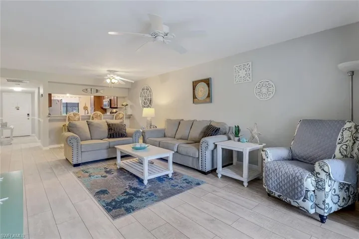 Living room featuring light wood-type flooring and a ceiling fan