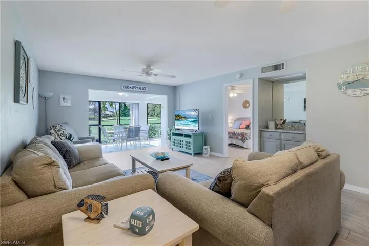 Living area with ceiling fan and light wood-type flooring