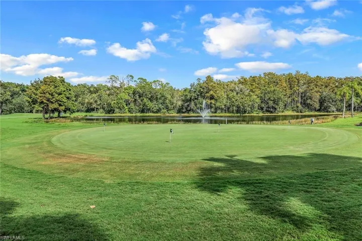 Surrounding community with a water view, golf course view, and view of wooded area