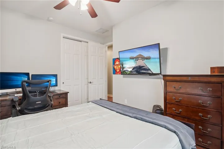 Bedroom featuring ceiling fan and a closet