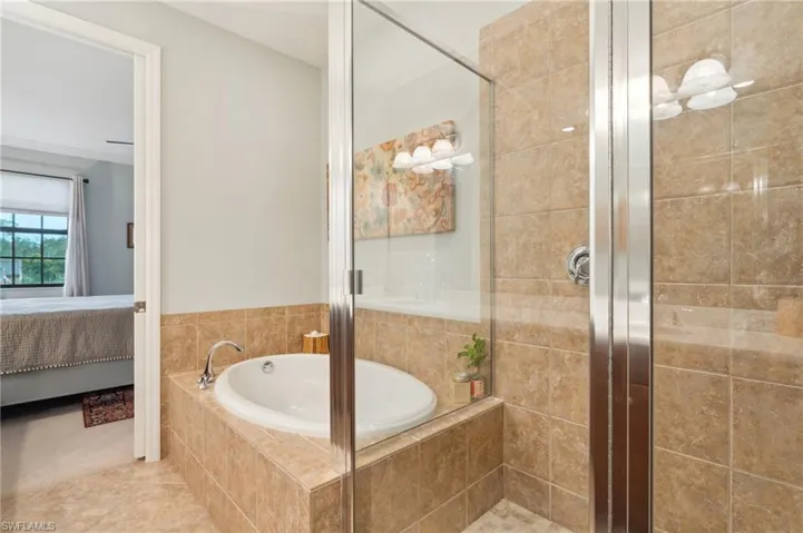 Bathroom featuring independent shower and bath and tile patterned floors