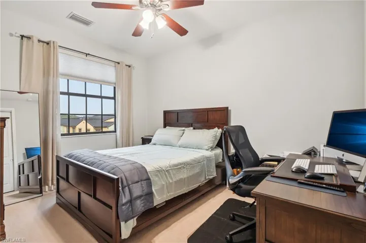 Carpeted bedroom with ceiling fan