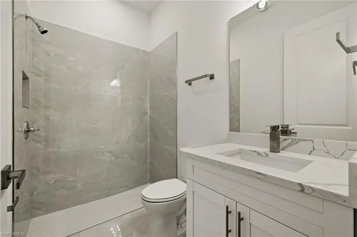 3rd Bathroom with tiled shower, vanity with quartz counter top
