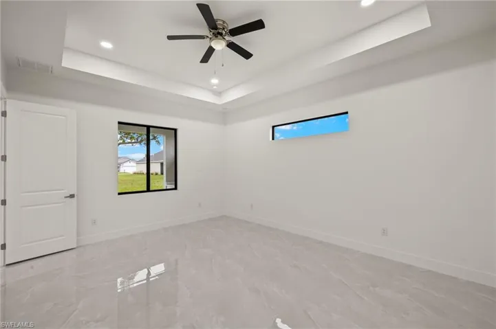 Spacious primary room with tray ceiling, double walk -in closets