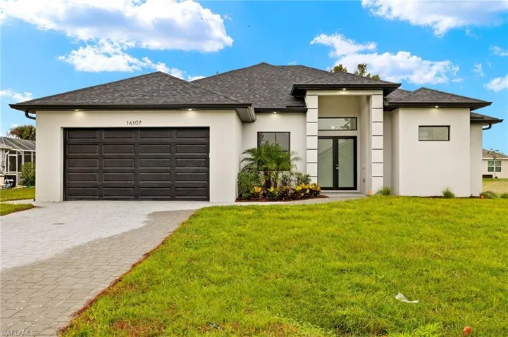 Driveway with modern paves, double door entry, beautiful landscaping