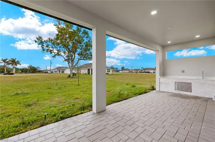 Spacious lanai, paved, quartz counter top and sink.