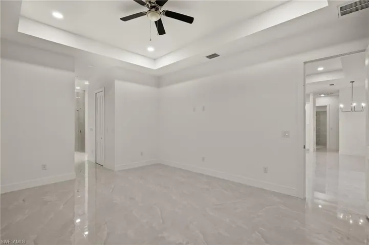 Spacious primary room with tray ceiling, double walk -in closets
