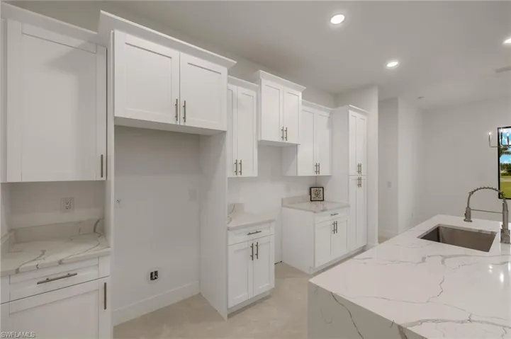 Plenty of cabinets, Quartz waterfall island. Appliance included.