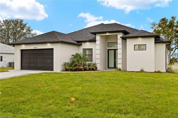 Driveway with modern paves, double door entry, beautiful landscaping