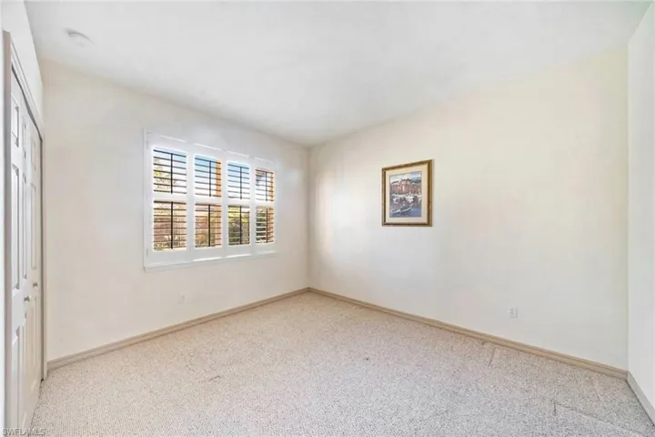 Spare room featuring light colored carpet