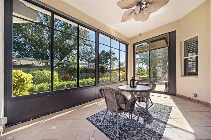 Sunroom with a wealth of natural light and ceiling fan