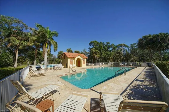 View of pool with an outdoor structure and a patio