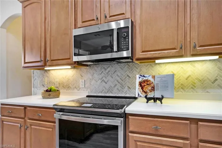 Kitchen with backsplash and stainless steel appliances
